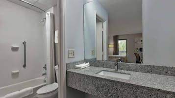 A modern bathroom with a shower, toilet, and sink.