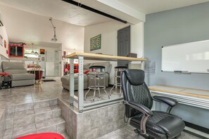 A modern living room with a glass shower enclosure, a sofa, a dining table with chairs, and a whiteboard on the wall. - 6 Mi to Spanish Springs! Private Unit w/ Projector (Lady Lake)