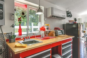 A kitchen with a wooden countertop, stainless steel sink, and red cabinetry. - 6 Mi to Spanish Springs! Private Unit w/ Projector (Lady Lake)