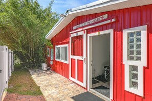 A red building with a sign that reads 'ENJOY THE BUILDING...'. - 6 Mi to Spanish Springs! Private Unit w/ Projector (Lady Lake)