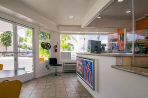 A restaurant interior with a counter, chairs, and a large window. - 2 QUEEN BEDS | NSMK, MINI FRIDGE (San Bernardino)