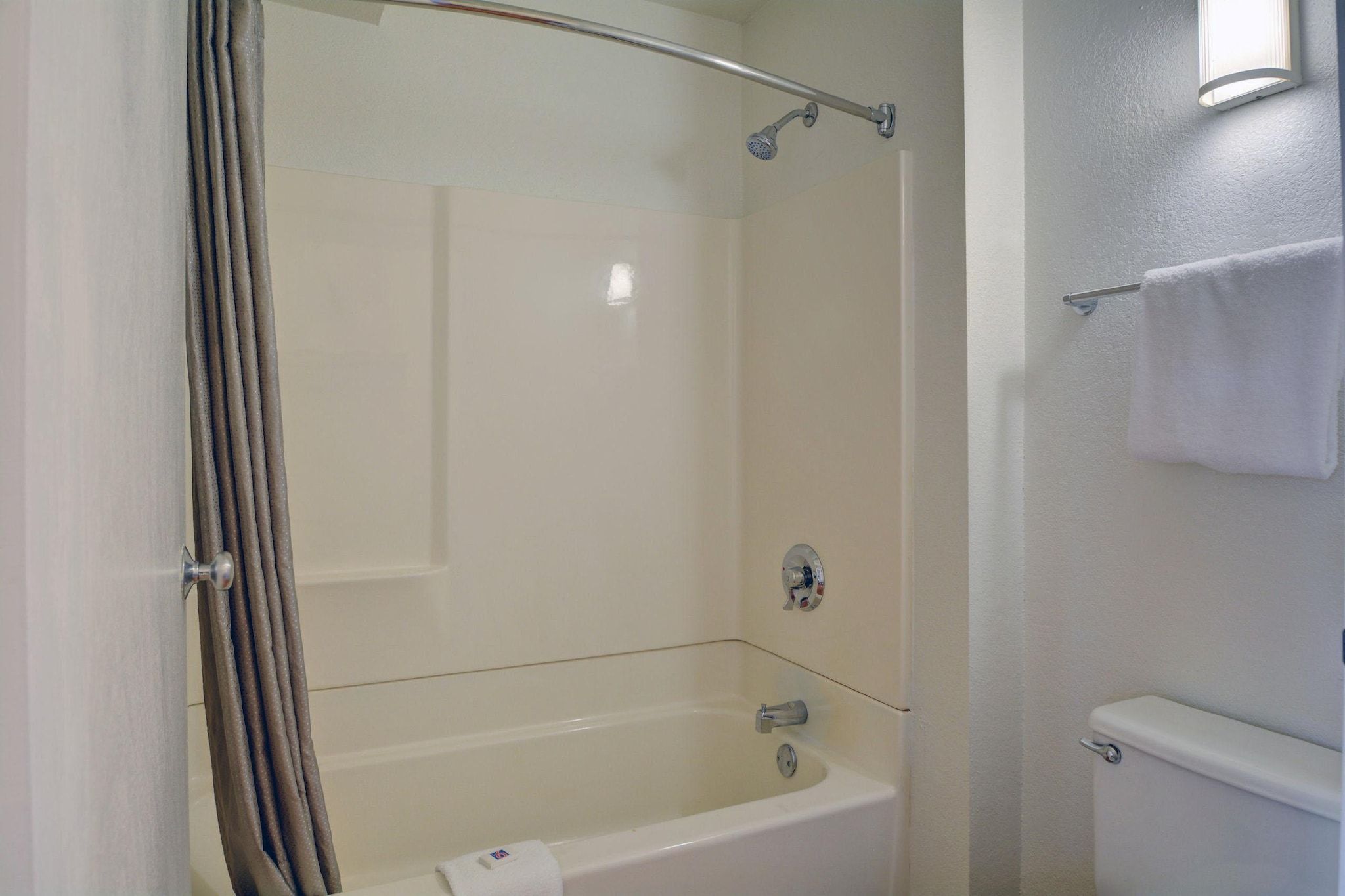 A bathroom with a bathtub, a shower, and a toilet.