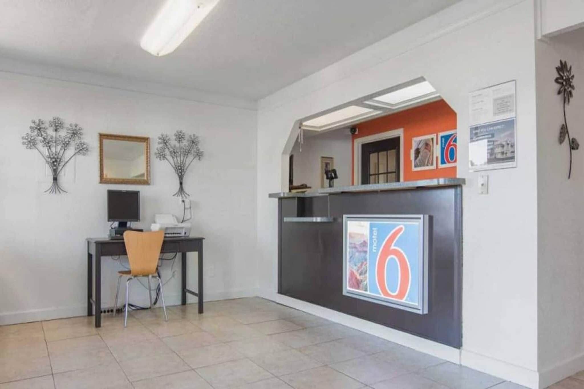 A reception area with a desk, chair, and a large number '6' sign.