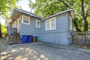 A two-story house with a garage, a wooden staircase, and a fenced yard. - Quaint North Campus Bungalow Minutes From Downtown (Austin)