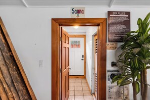 A spa entrance with a wooden door, a sign indicating spa rules, and a plant on the right. - Private Pool & Hot Tub! Luxe South Lake Tahoe Gem (South Lake Tahoe)