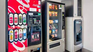 Three beverage vending machines with Coca-Cola, Dr. Pepper, and Sprite options.