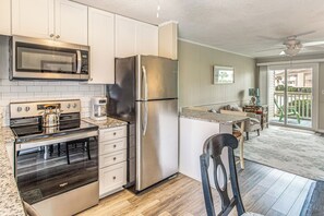 A modern kitchen with stainless steel appliances, a microwave, and a coffee maker. - Walk to Ocean & Eats! Lake-View Myrtle Beach Haven (North Myrtle Beach)