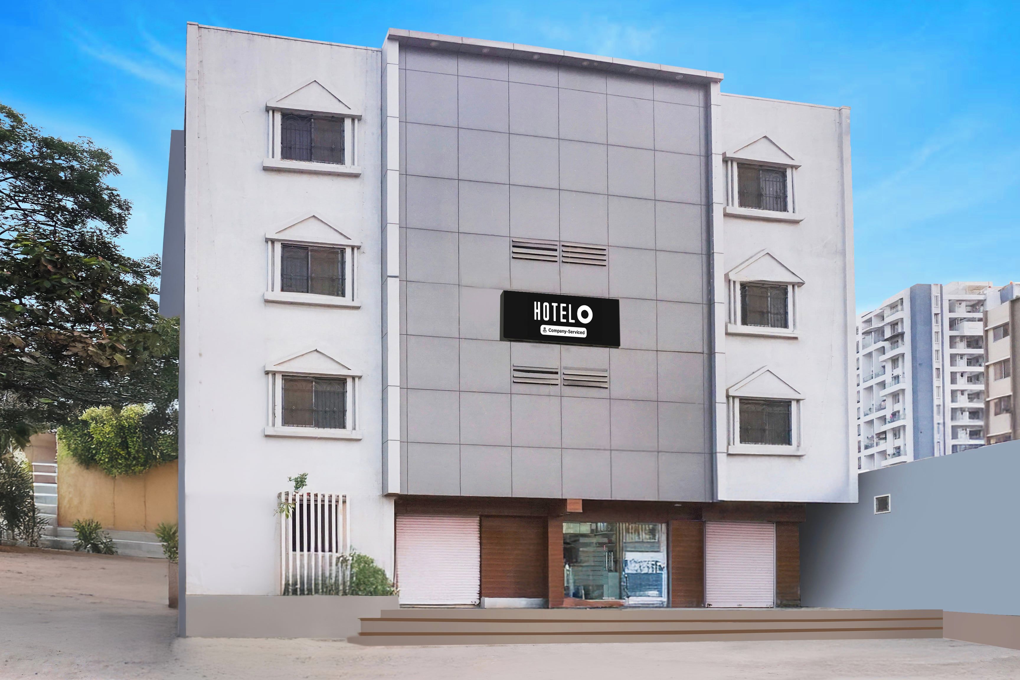 A modern hotel building with a prominent sign reading 'HOTEL'.