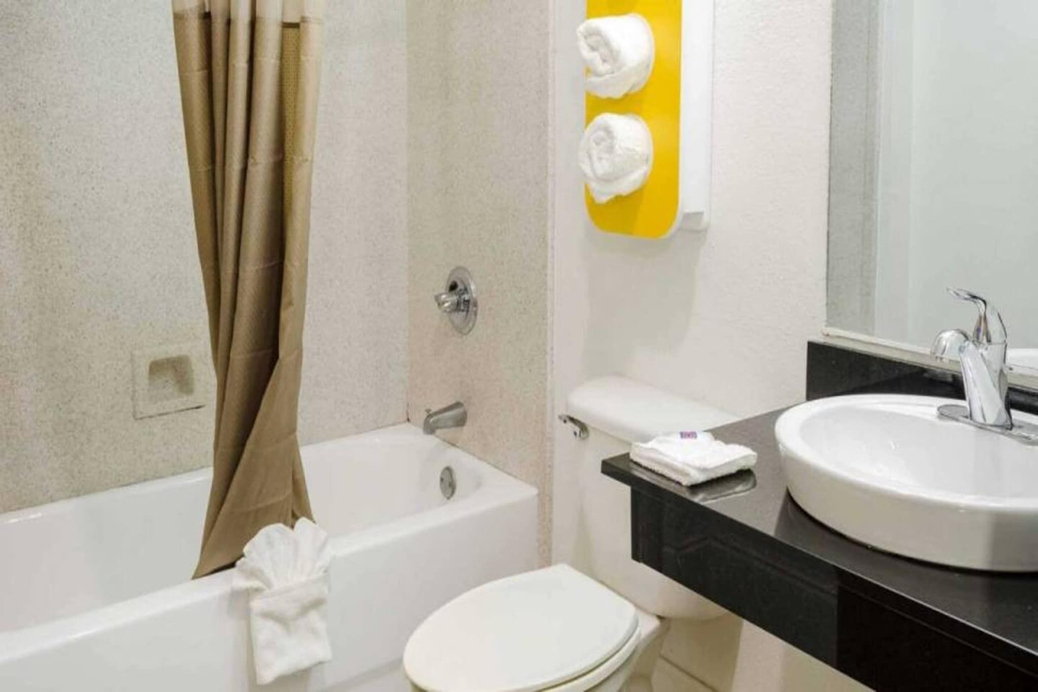 A bathroom with a bathtub, toilet, and sink.