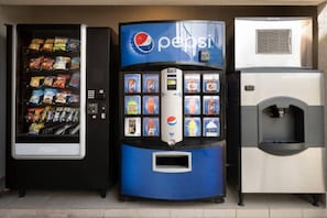 A vending machine with a Pepsi logo, a refrigerated display case, and a water dispenser.