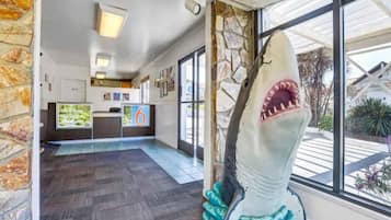 A reception area with a shark sculpture, a reception desk, and framed pictures on the wall.