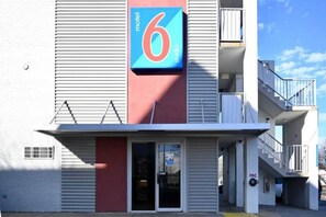 A building with a prominent '6' sign, indicating a motel. - 2 Queen Beds|NS| Kitchen (Little Rock AR)