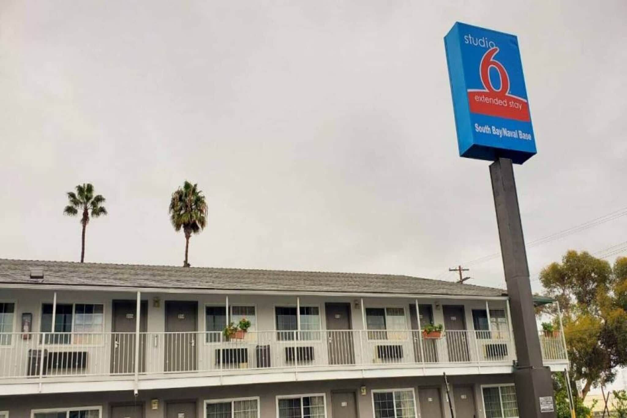 A motel with a sign indicating it is Studio 6 Extended Stay at South Bay/Naval Base.