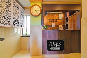 A reception desk with a clock, a sign reading 'IUBIT', and a 'Collection' sign below. - Collection O Kalyani Expressway Kolkata (Barakpur)