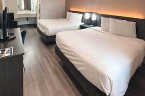 A hotel room with two beds, a desk, and a television. - Stylish Full Beds|Pool|Free Wifi&TV (WEST SACRAMENTO)