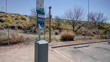 A parking lot with a sign indicating a waste disposal area.