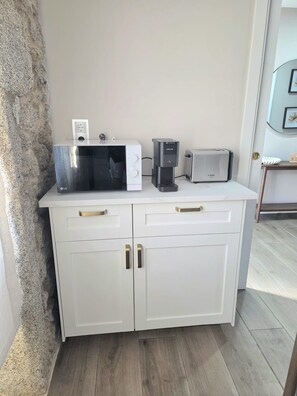 A kitchenette with a microwave, toaster, and coffee maker on a white countertop. - ZOILA HOUSE (Queiruga- Porto do Son)