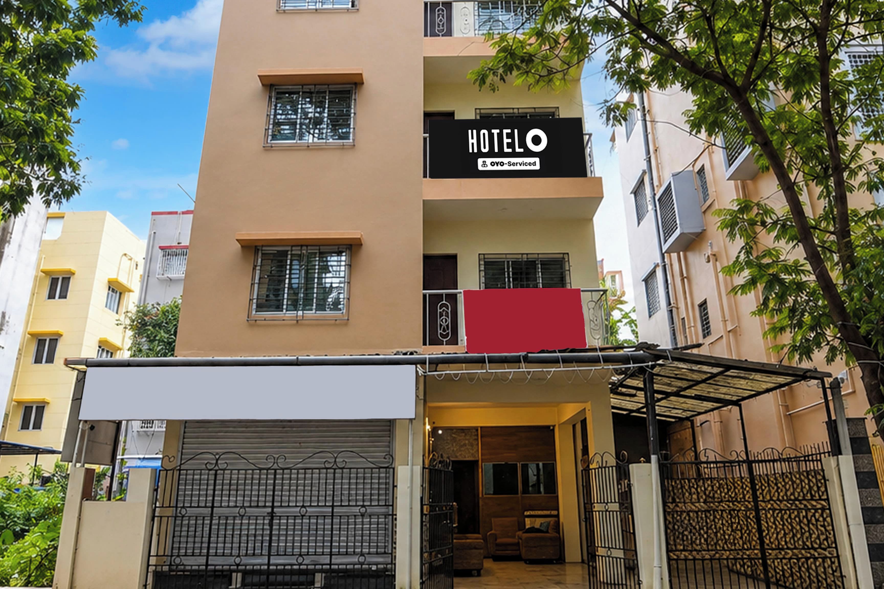 A hotel with a closed entrance, a visible balcony, and a sign indicating it is serviced by OYO.
