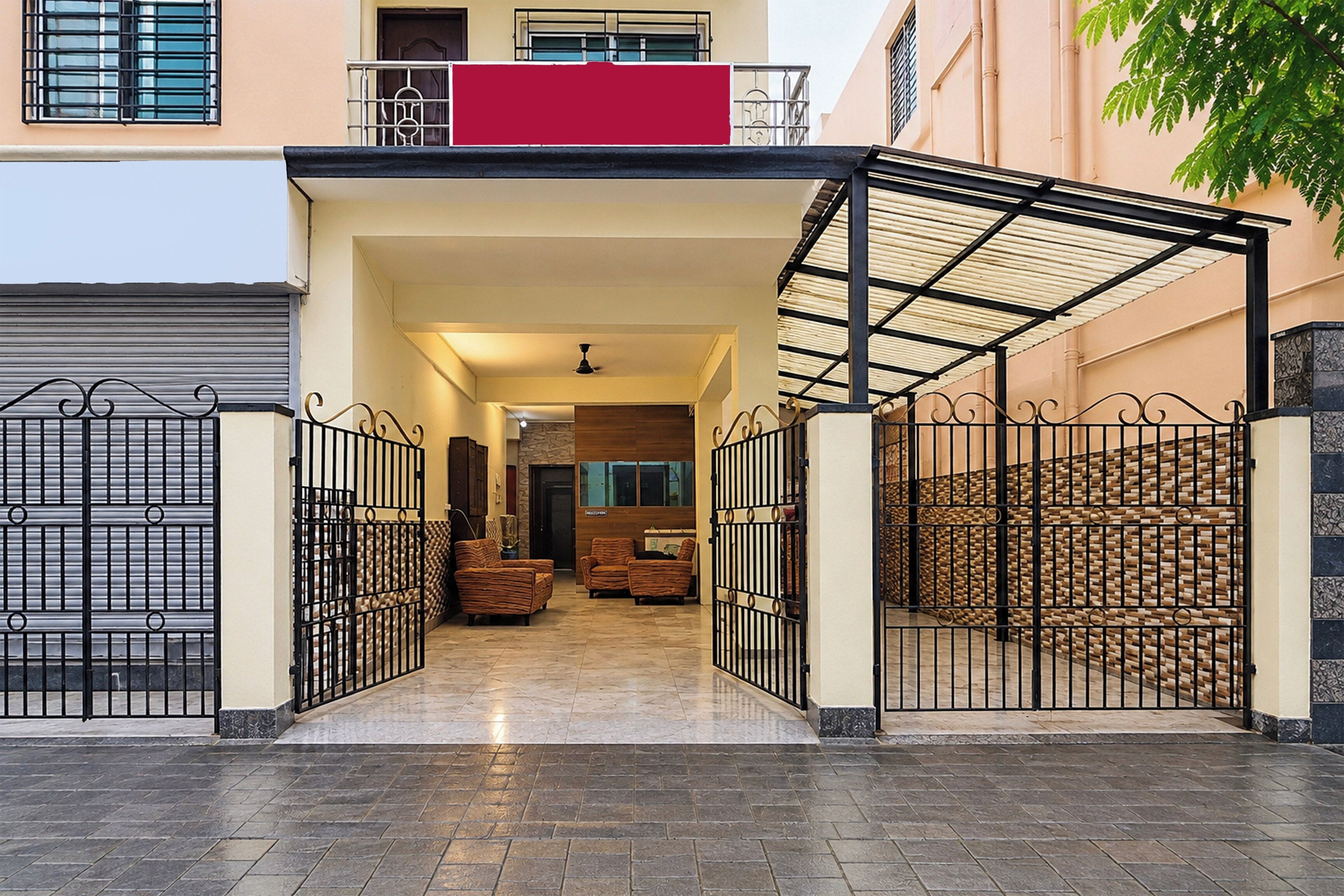 A gated entrance with a covered walkway leading to a building.