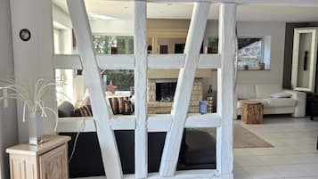 Un salon moderne avec un plafond blanc, une cheminée, un canapé et une table basse.