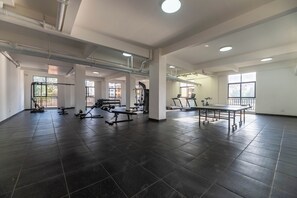 A spacious gym with exercise equipment, large windows, and a tiled floor. - Cozy 2-bedroom apartment in beautiful Westlands Nairobi (Westlands, Nairobi, Nairobi)