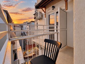 A balcony with a chair, a view of the cityscape, and a building with a white facade. - 6th Floor Loft in the Heart of Athens Ι by ΜΡS (Athina)
