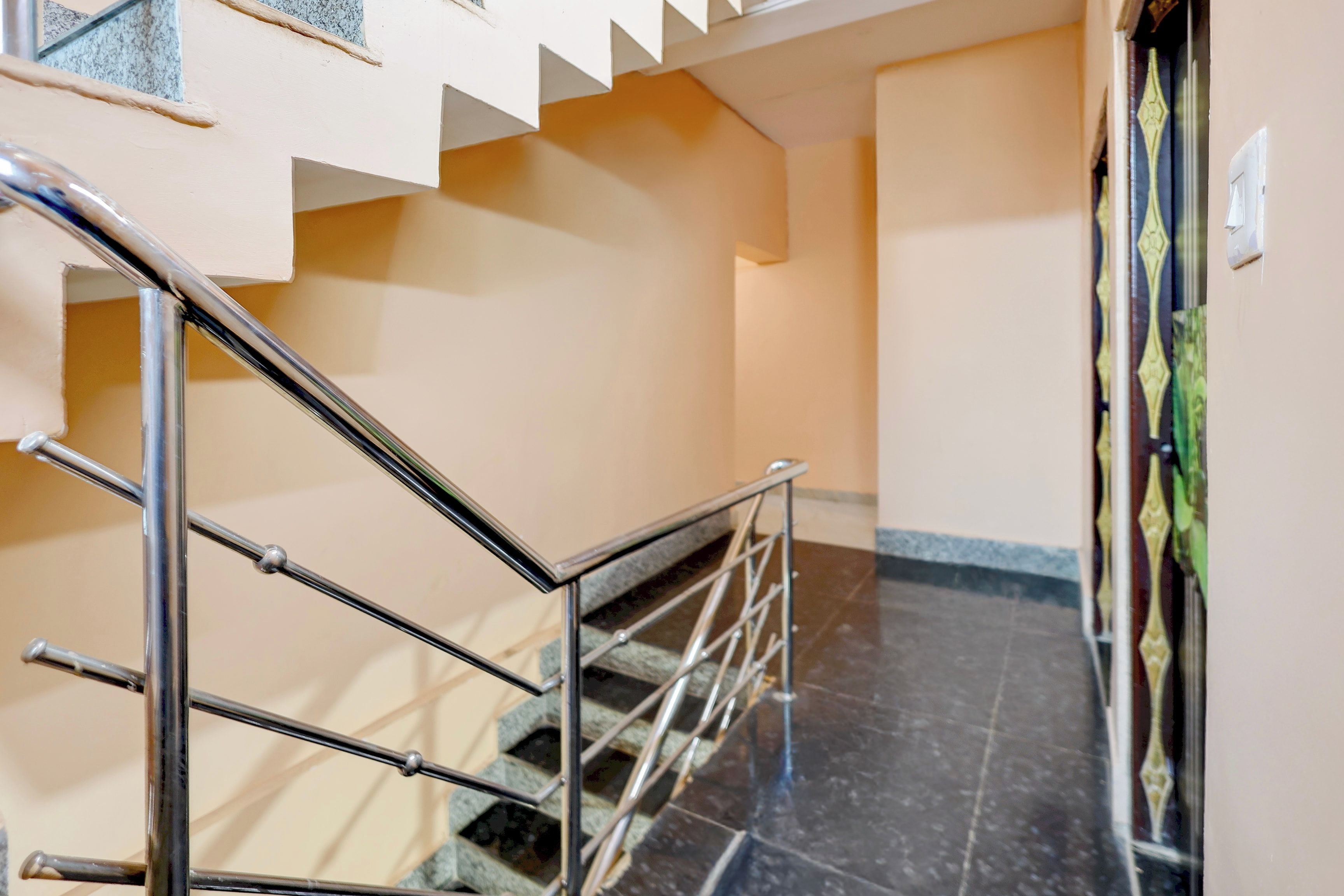 A staircase with metal railings leading to a landing.
