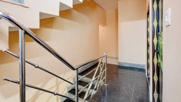 A staircase with metal railings leading to a landing.