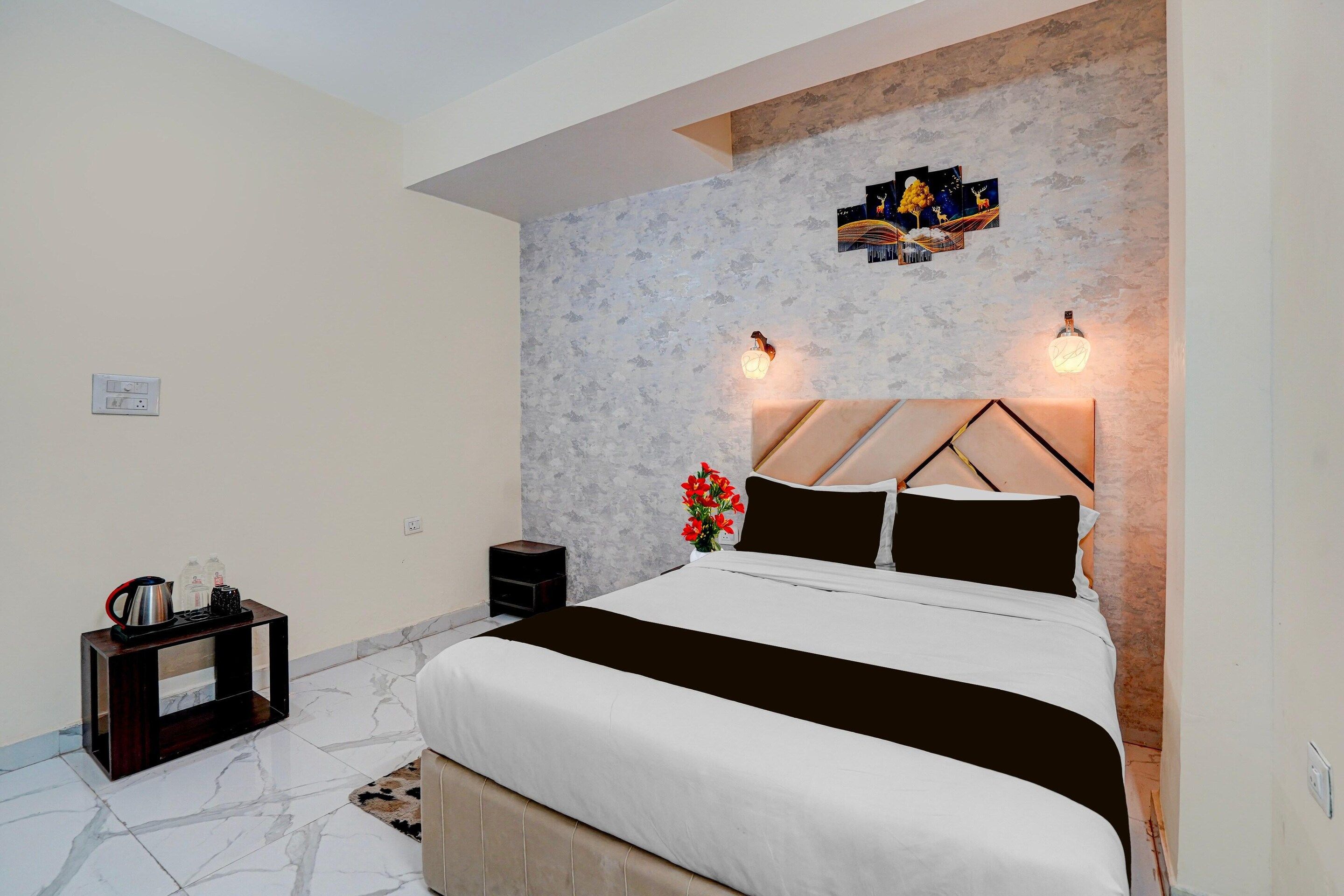 A modern bedroom with a bed, nightstand, and decorative wall art.