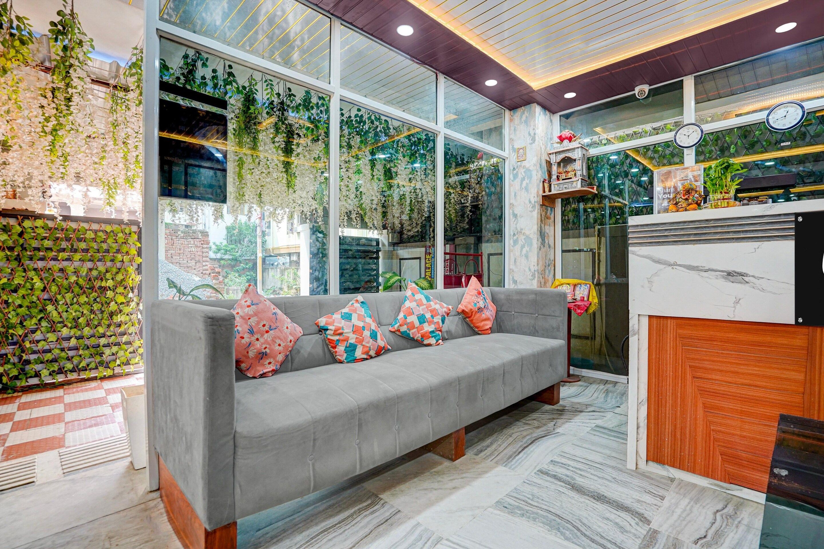 A modern interior with a grey sofa, patterned cushions, and a checkered floor.