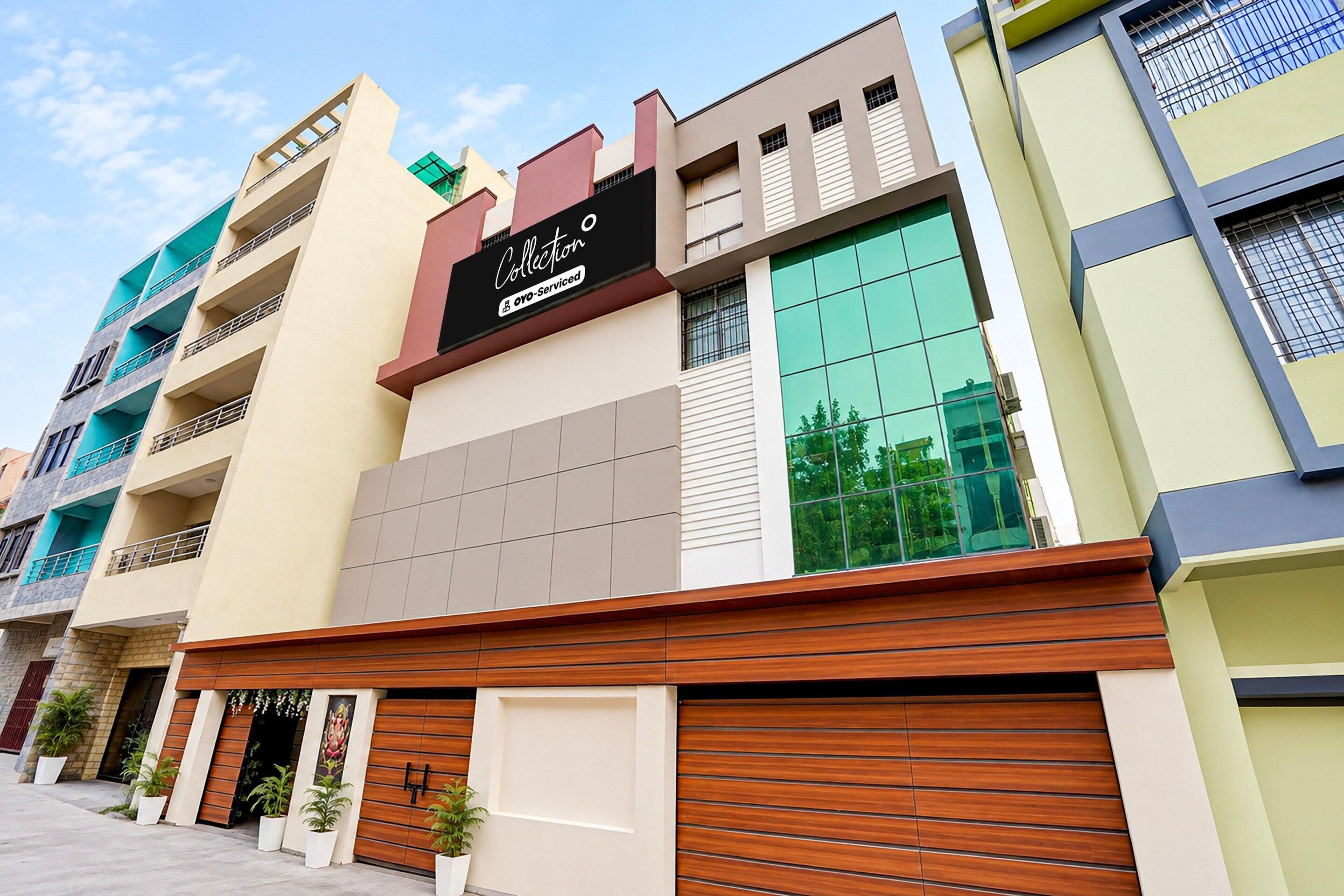 A multi-story building with a prominent 'Collection' sign, large windows, and a garage door.