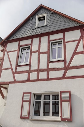 A half-timbered building with a gabled roof and multiple windows.