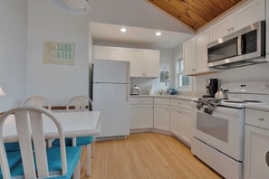 A modern kitchen with white cabinetry, a built-in oven, and a microwave. - 2/10 of a mile to Long Sands Beach via Webber Road! 2BD/1BA duplex, ( Unit 1) sleeps 6, with in-unit laundry, mini-splits, and a stocked kitchen. Rent both sides for a two-family getaway. Parking for 2, steps from beaches, shops, and dining. (York)