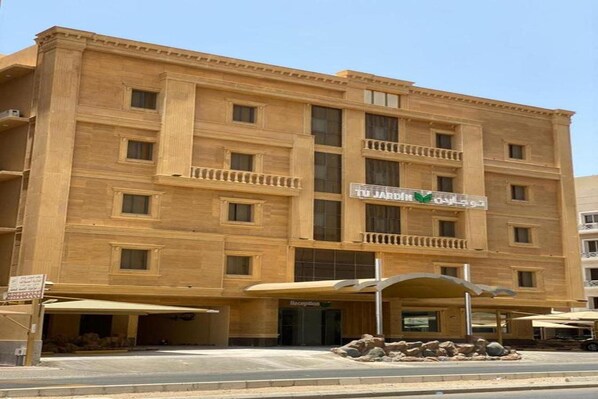 A multi-story hotel with a beige facade, balconies, and a reception area. - Tu Jardin Al Harmain Jeddah (Jeddah)