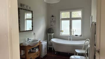 A bathroom with a freestanding bathtub, a sink, and a toilet.