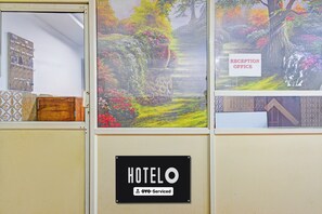 A hotel reception area with a sign indicating the reception office. - Hotel O Sadashivpet Bus Terminal (Sadasivpet)