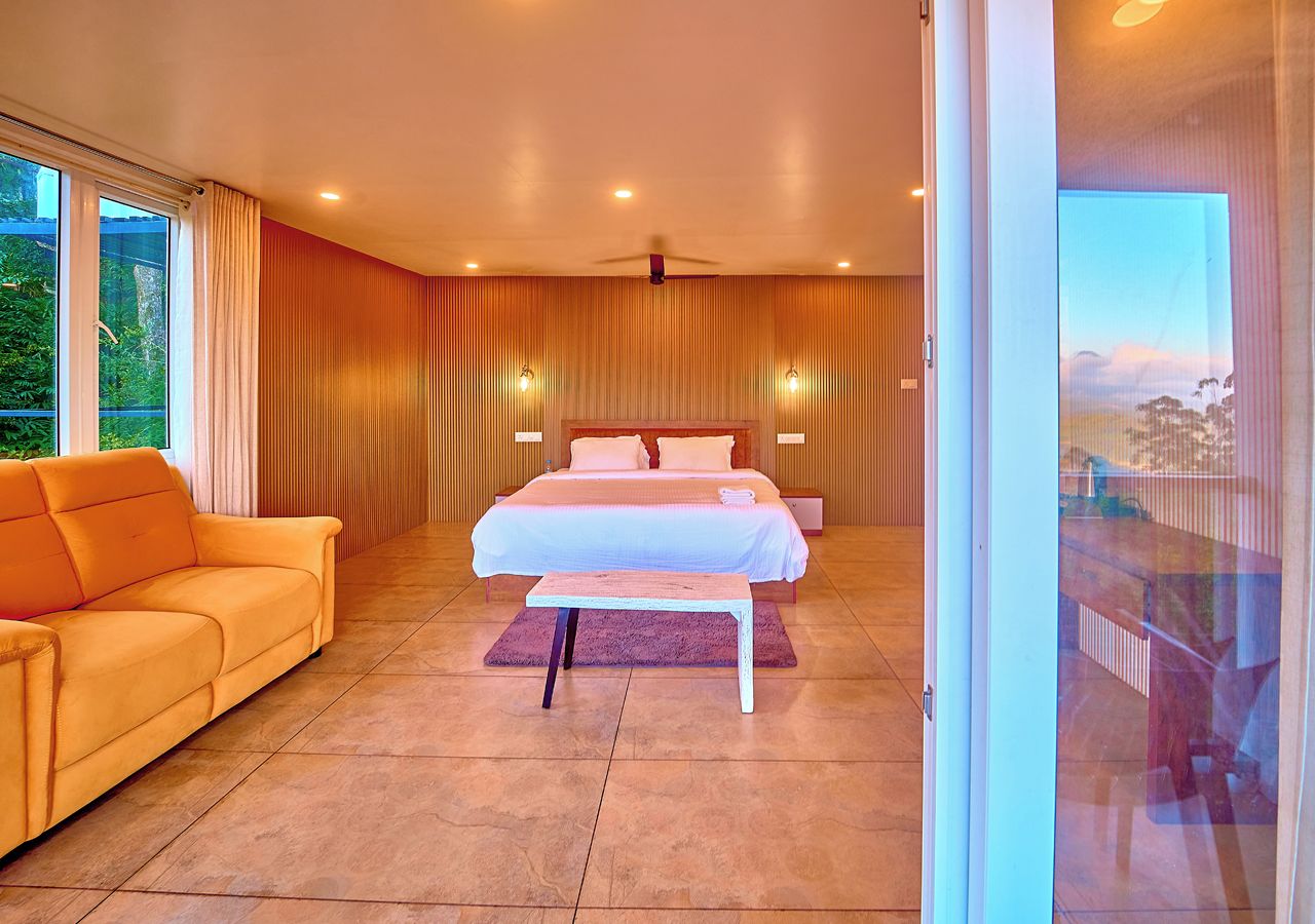 Ein Schlafzimmer mit einem Bett, einem Sofa und einem großen Fenster.