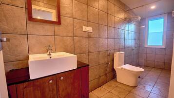 Ein Badezimmer mit Waschbecken, Toilette und Dusche.