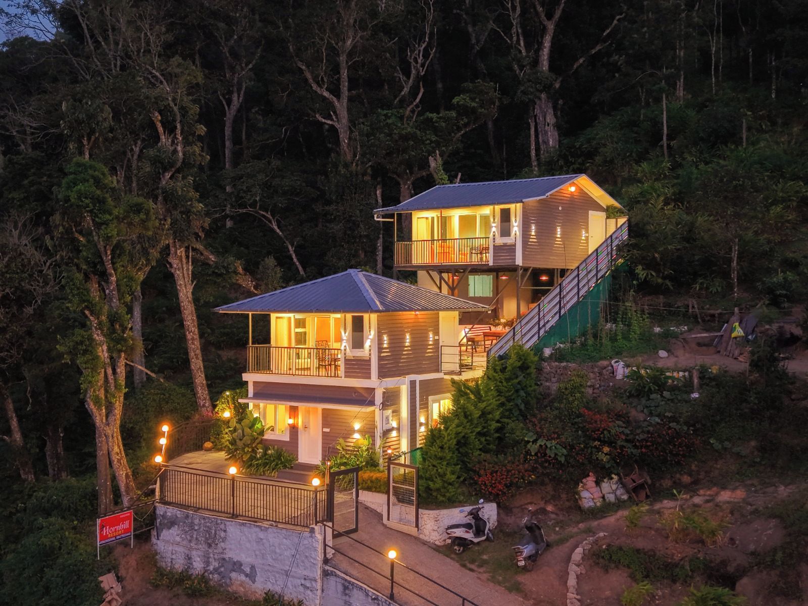 A two-story building with a balcony and a staircase leading to the upper level.