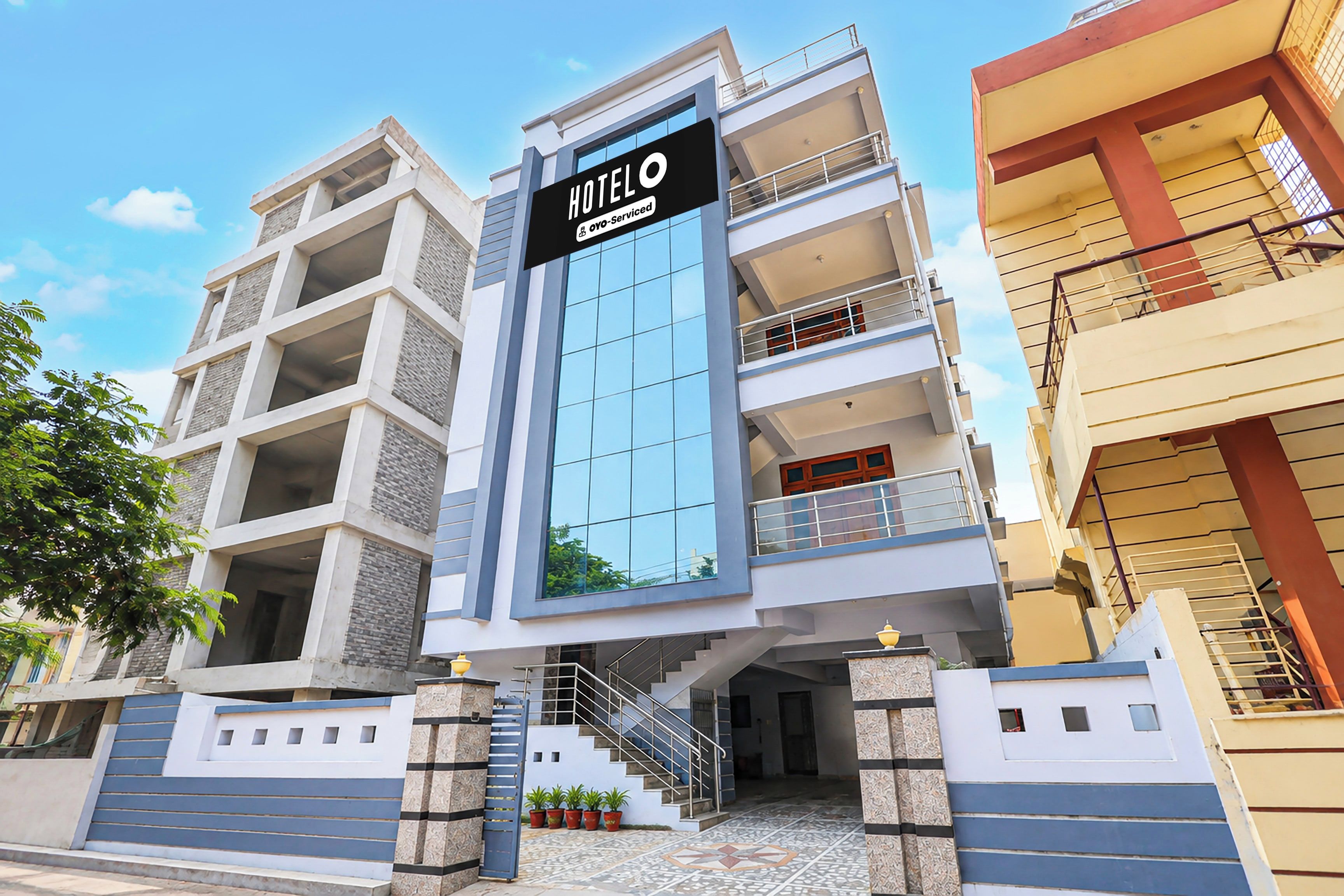 A multi-story hotel building with a prominent sign indicating it is fully serviced.