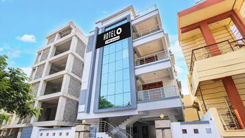 A multi-story hotel building with a prominent sign indicating it is fully serviced.
