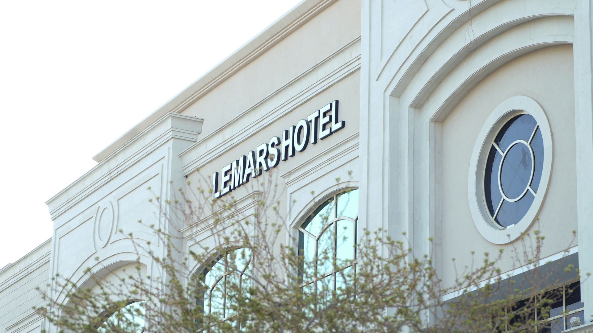 A hotel sign with the name 'LEMARSHOTEL' on a building facade.