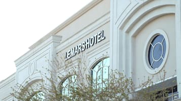 A hotel sign with the name 'LEMARSHOTEL' on a building facade.