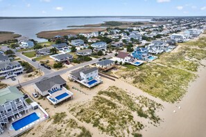 A coastal residential area with houses, a beach, and a large body of water. - Healing Breezes | Oceanfront • Private Pool • 7BR Luxury Retreat (Virginia Beach)