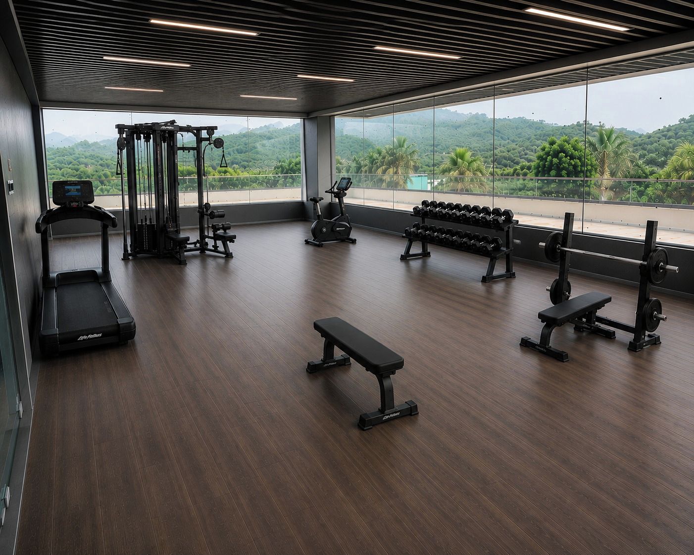 Une salle de sport équipée de machines de cardio, de poids libres et d’haltères.