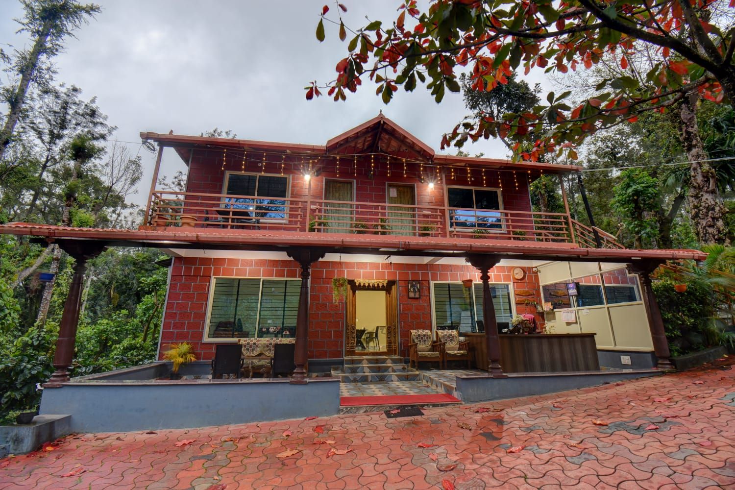 A two-story building with a balcony, a staircase, and a front entrance.