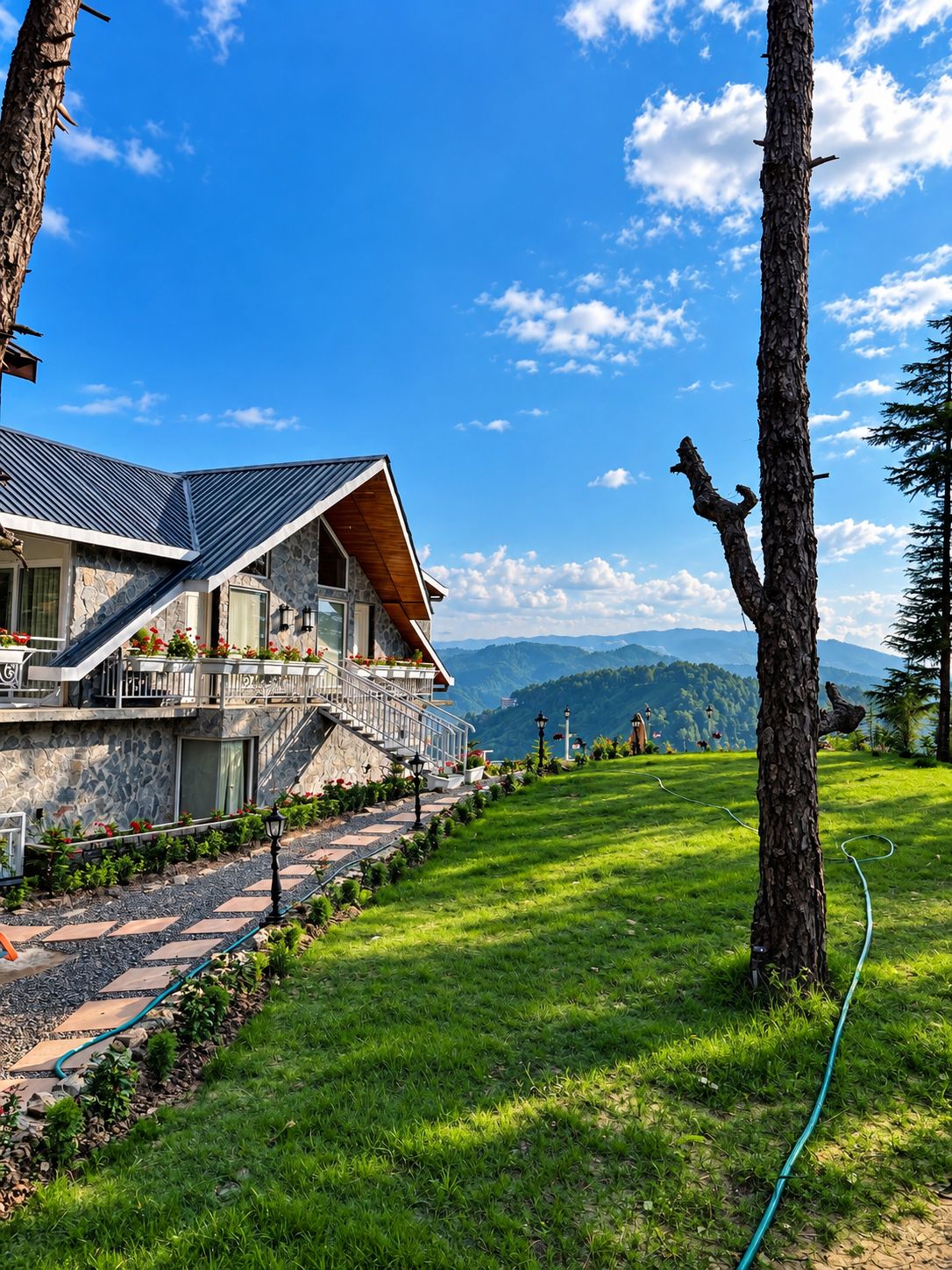 A modern house with a stone facade, a sloped roof, and a stone staircase leading to a balcony.