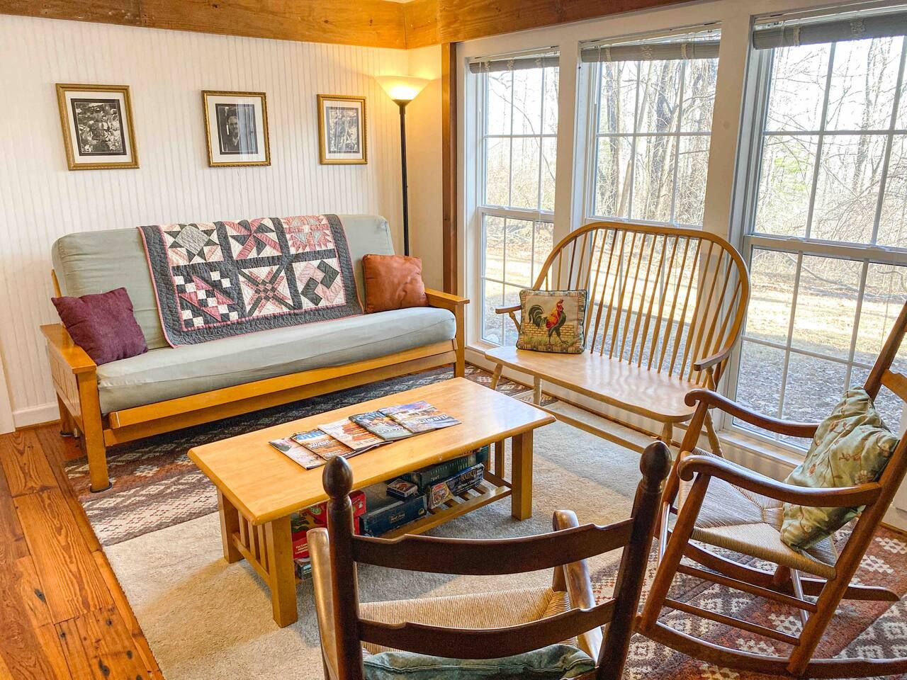 A cozy living room with a sofa, a coffee table, and two rocking chairs.