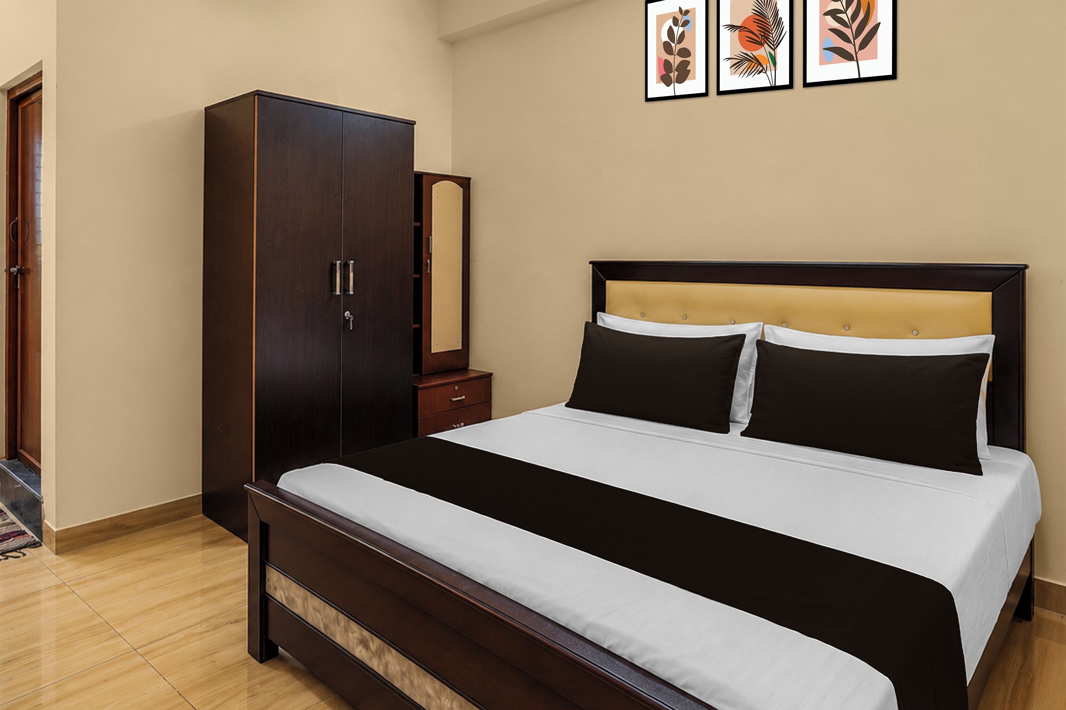 A bedroom with a bed, a wardrobe, and a nightstand.