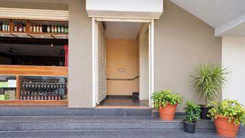 A hotel entrance with a staircase leading to a reception area.